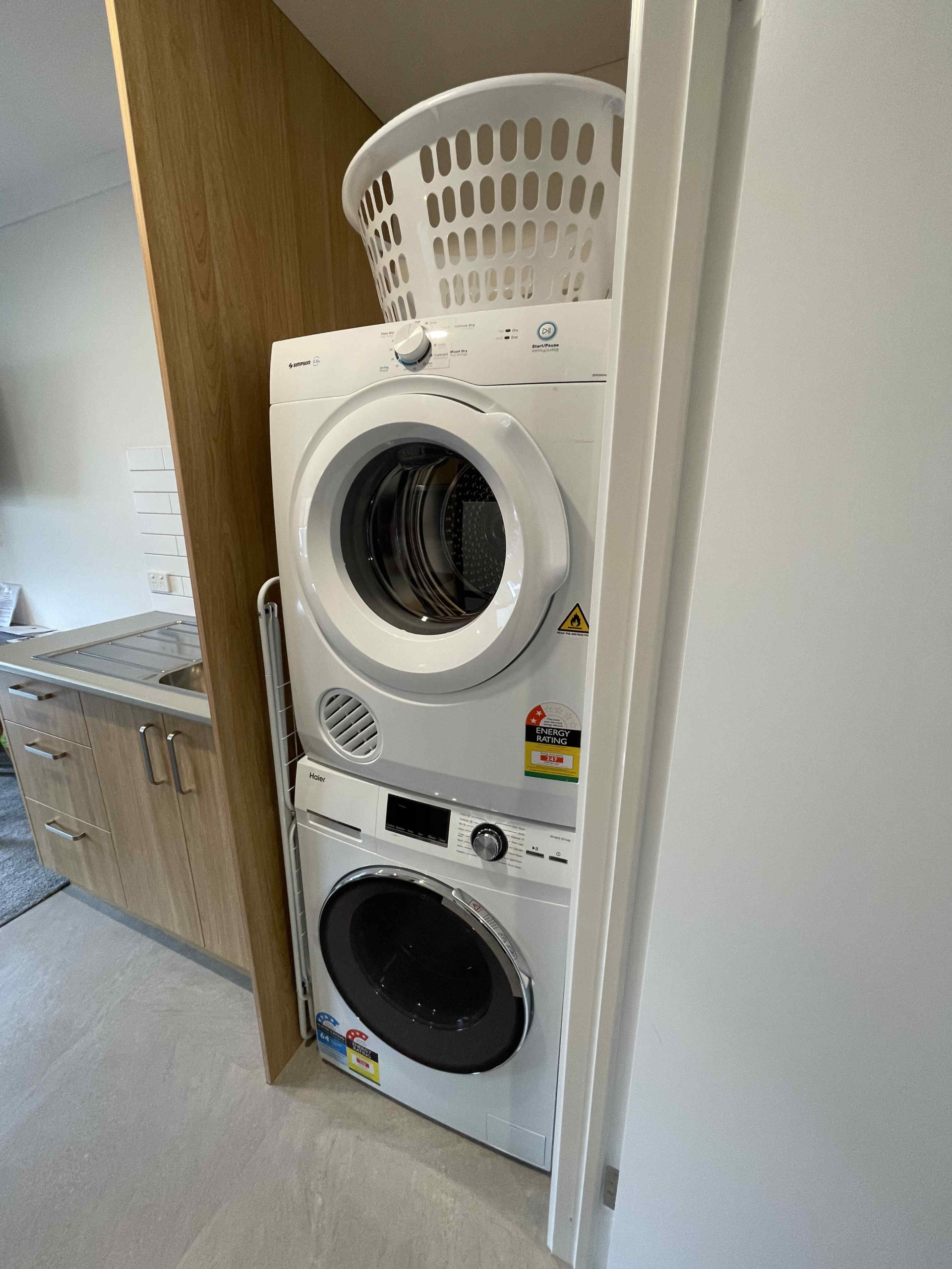 Laundry (washing machine and dryer) in one bedroom apartment with one king bed and one single bed